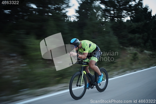 Image of triathlon athlete riding bike at night