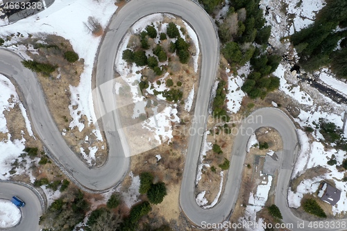 Image of alpine curvy road on winter top view