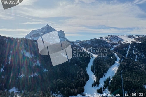 Image of aerial snow covered mountain peaks in alps at winter 