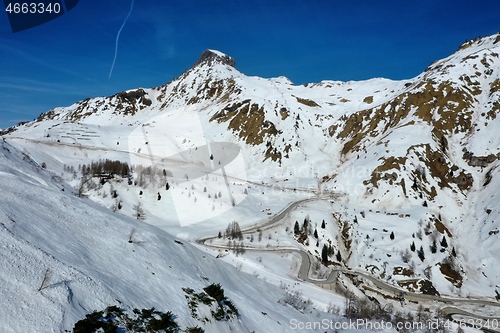 Image of aerial snow covered mountain peaks in alps at winter 