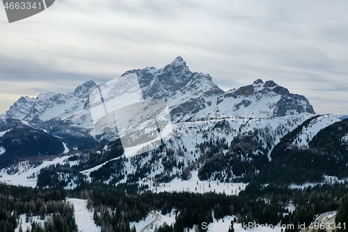 Image of aerial snow covered mountain peaks in alps at winter 