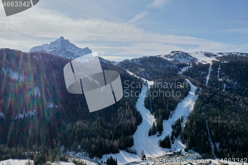 Image of aerial snow covered mountain peaks in alps at winter 