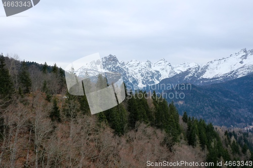 Image of aerial snow covered mountain peaks in alps at winter 