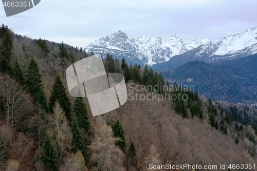 Image of aerial snow covered mountain peaks in alps at winter 