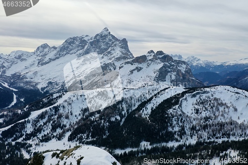 Image of aerial snow covered mountain peaks in alps at winter 