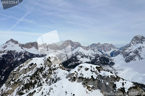 Image of aerial snow covered mountain peaks in alps at winter 