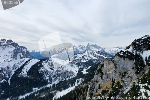 Image of aerial snow covered mountain peaks in alps at winter 