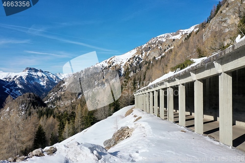 Image of aerial snow covered mountain peaks in alps at winter 