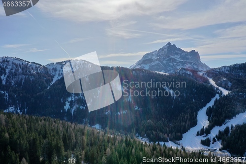 Image of aerial snow covered mountain peaks in alps at winter 