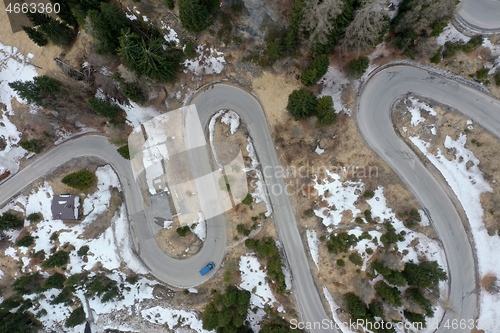 Image of alpine curvy road on winter top view