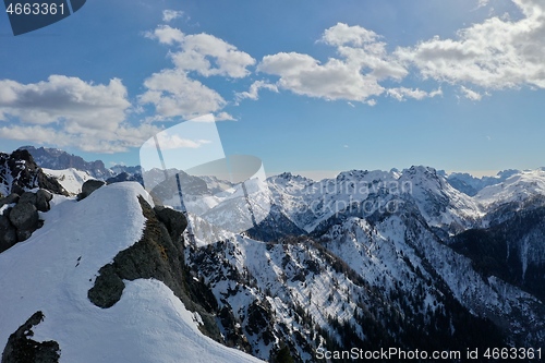 Image of aerial snow covered mountain peaks in alps at winter 