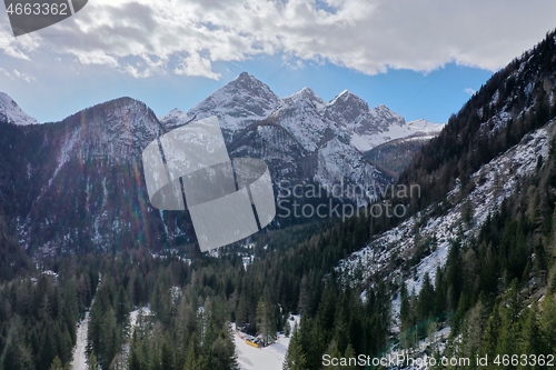 Image of aerial snow covered mountain peaks in alps at winter 