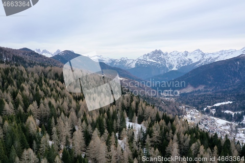 Image of aerial snow covered mountain peaks in alps at winter 