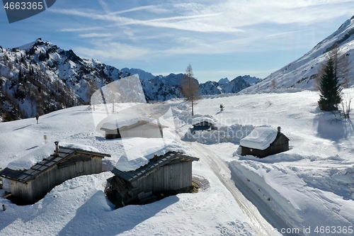 Image of aerial snow covered mountain peaks in alps at winter 