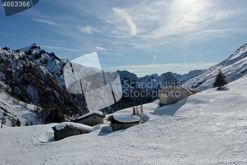 Image of aerial snow covered mountain peaks in alps at winter 