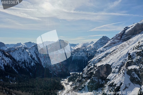 Image of aerial snow covered mountain peaks in alps at winter 