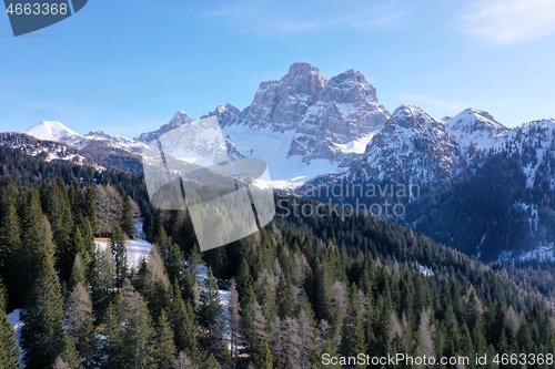 Image of aerial snow covered mountain peaks in alps at winter 