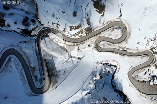 Image of aerial snow covered mountain peaks in alps at winter 