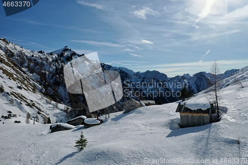 Image of aerial snow covered mountain peaks in alps at winter 