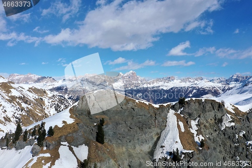 Image of aerial snow covered mountain peaks in alps at winter 