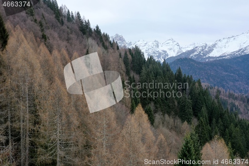 Image of aerial snow covered mountain peaks in alps at winter 