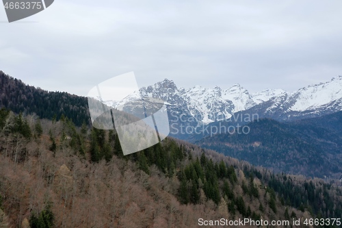 Image of aerial snow covered mountain peaks in alps at winter 