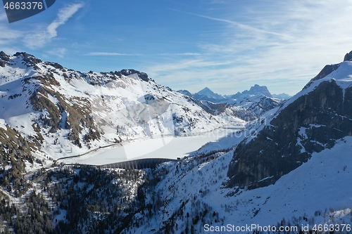 Image of aerial snow covered mountain peaks in alps at winter 