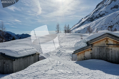 Image of aerial snow covered mountain peaks in alps at winter 