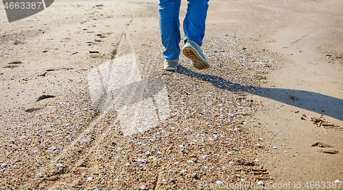 Image of man walking on the beach