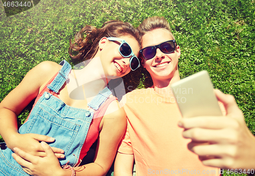 Image of happy couple taking selfie on smartphone at summer