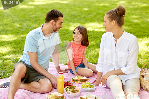 Image of happy family having picnic at summer park