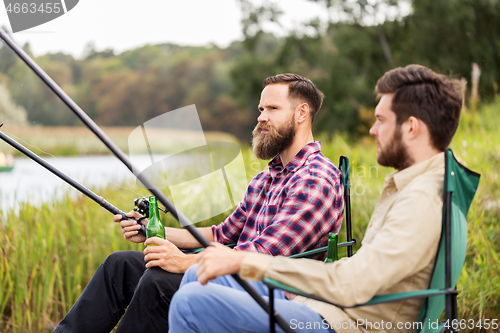 Image of male friends fishing and drinking beer on lake