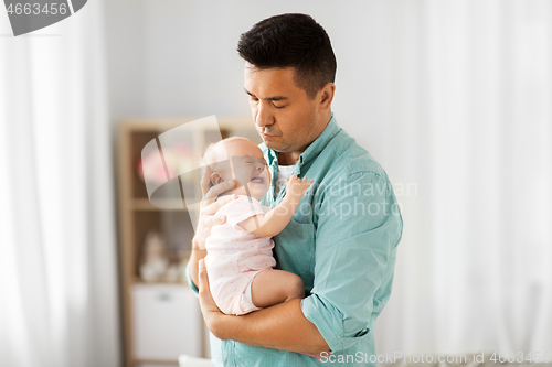 Image of middle aged father with baby daughter at home