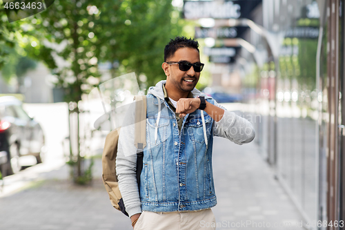 Image of indian man recording voice message by smart watch