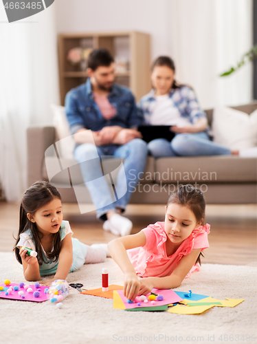 Image of happy sisters doing arts and crafts at home