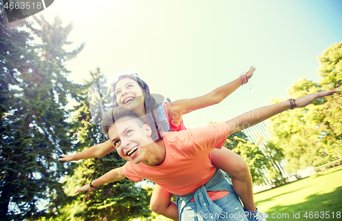 Image of happy teenage couple having fun at summer park