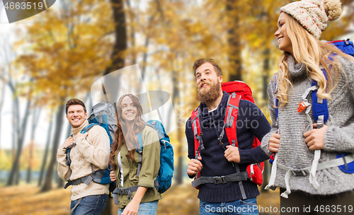 Image of friends with backpacks hiking in autumn