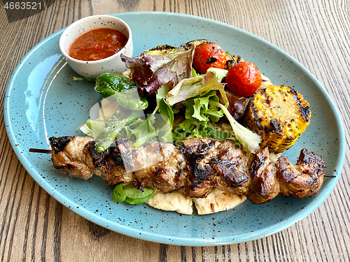 Image of pork kebab meat on wooden skewer