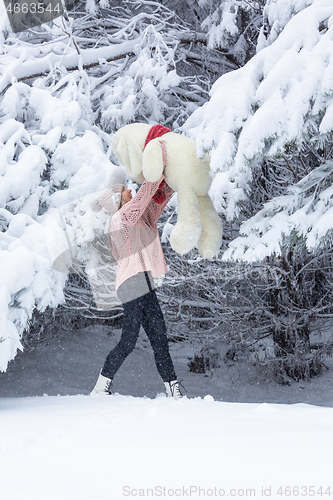 Image of Happy go lucky woman playing in snow