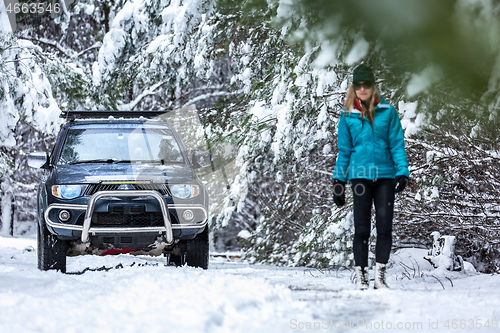 Image of Out in snow covered forest with 4wd ute