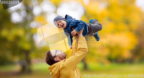 Image of father with son playing and having fun in autumn