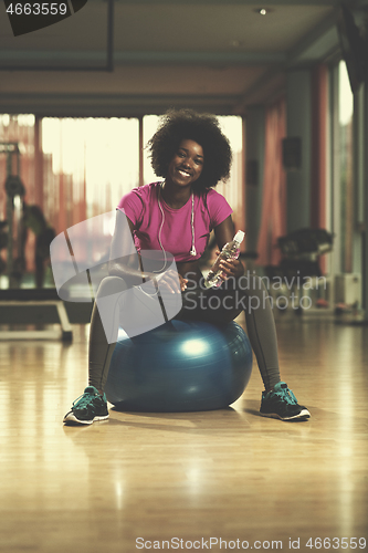 Image of woman  relaxing after pilates workout