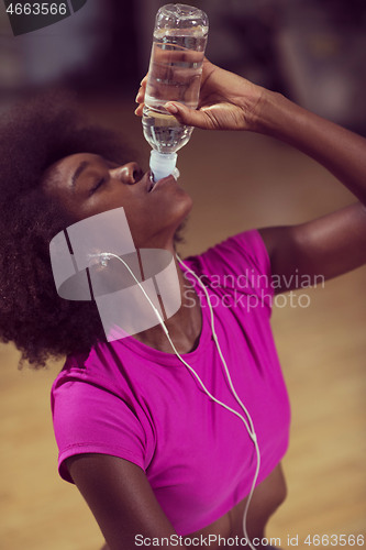 Image of young afro american woman in gym have pilates workout break