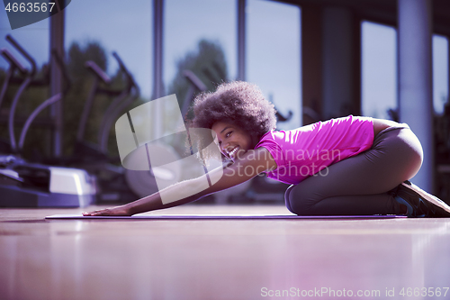 Image of african american woman exercise yoga in gym