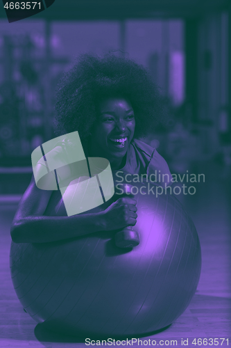 Image of woman  relaxing after pilates workout