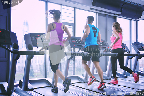 Image of Group of people running on treadmills