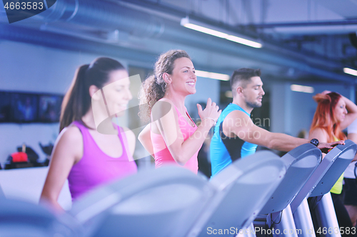 Image of Group of people running on treadmills