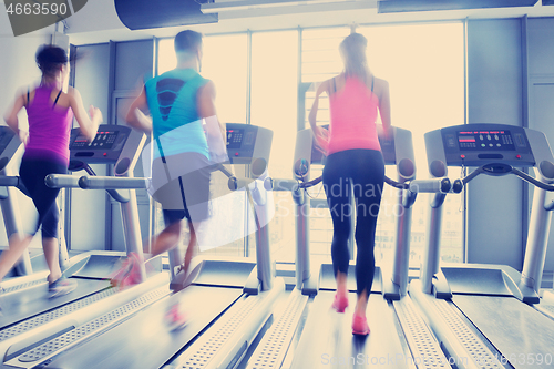 Image of Group of people running on treadmills