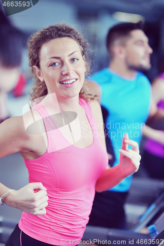 Image of woman exercising on treadmill in gym