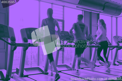 Image of Group of people running on treadmills